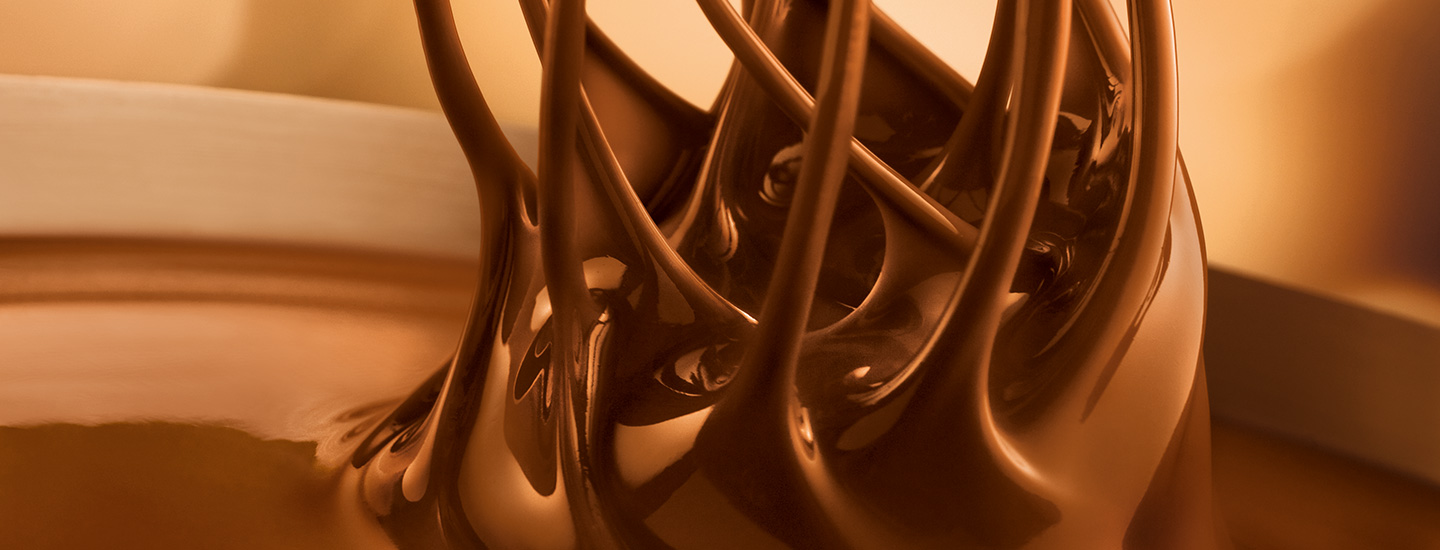 Fine Lindt chocolate is stirred with whisks Fine Lindt chocolate is stirred with whisks