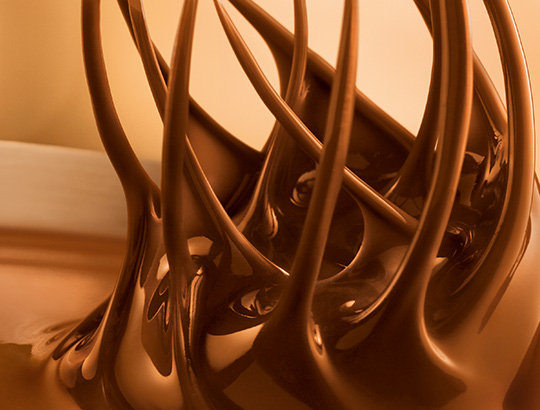 Fine Lindt chocolate is stirred with whisks Fine Lindt chocolate is stirred with whisks