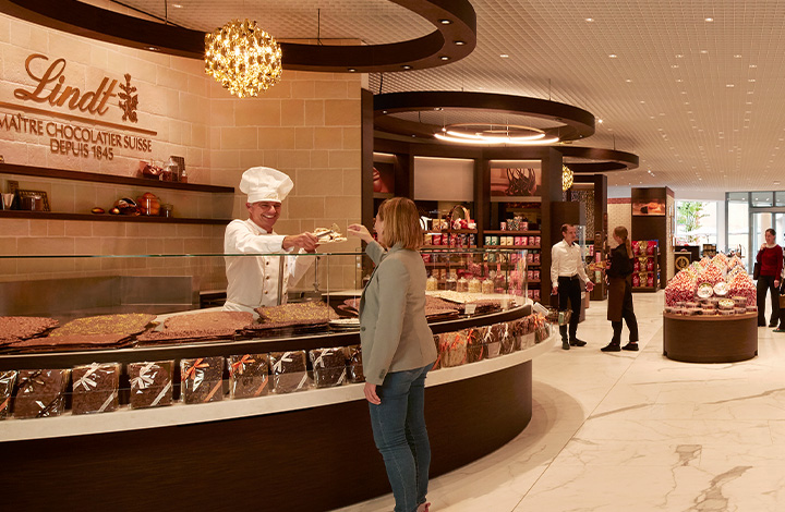 A real Lindt Master Chocolatier inspects a freshly made chocolate bar A real Lindt Master Chocolatier inspects a freshly made chocolate bar
